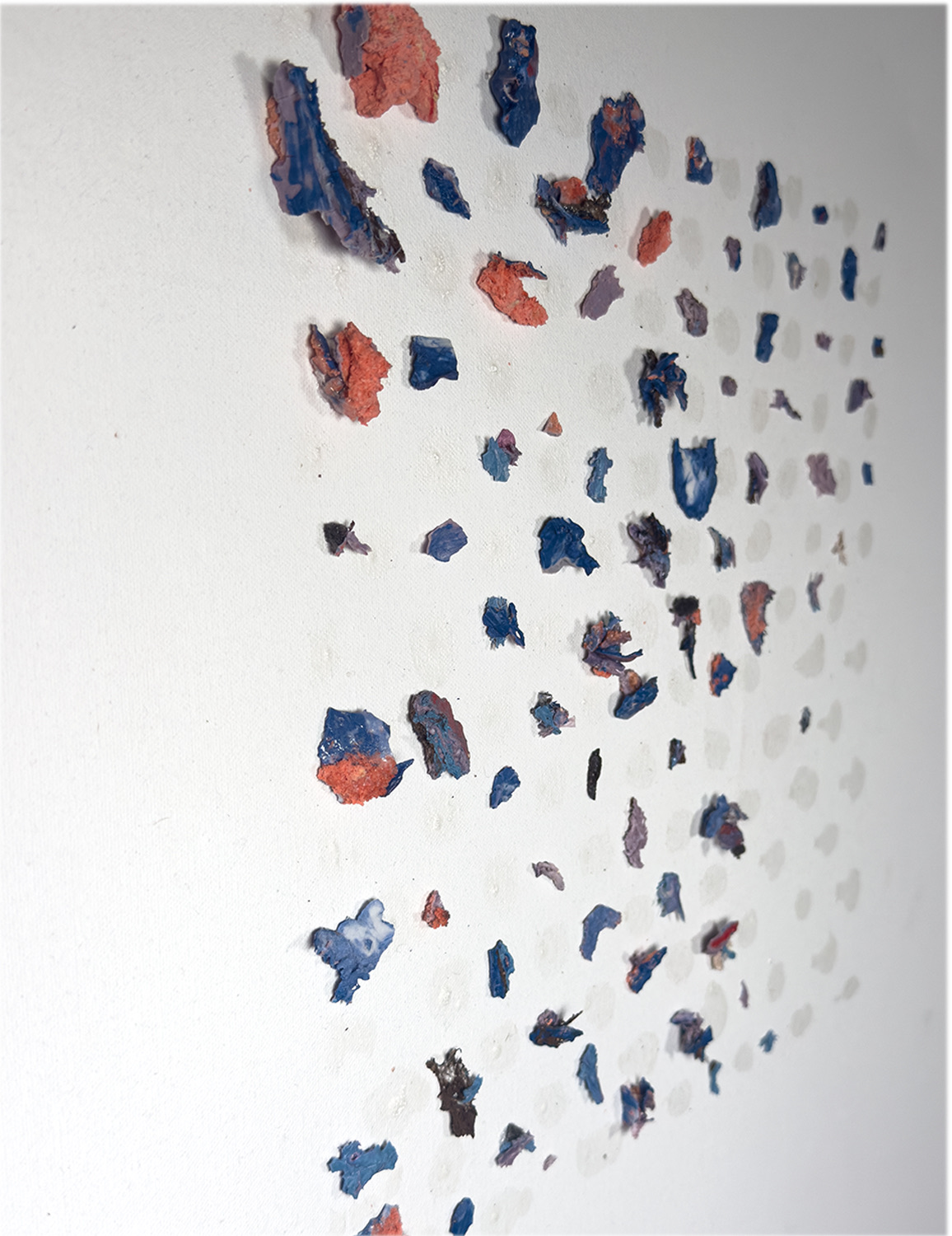 Splinters in Order — blue and orange porcelain splinters on a wall in a loose grid, seen from the side