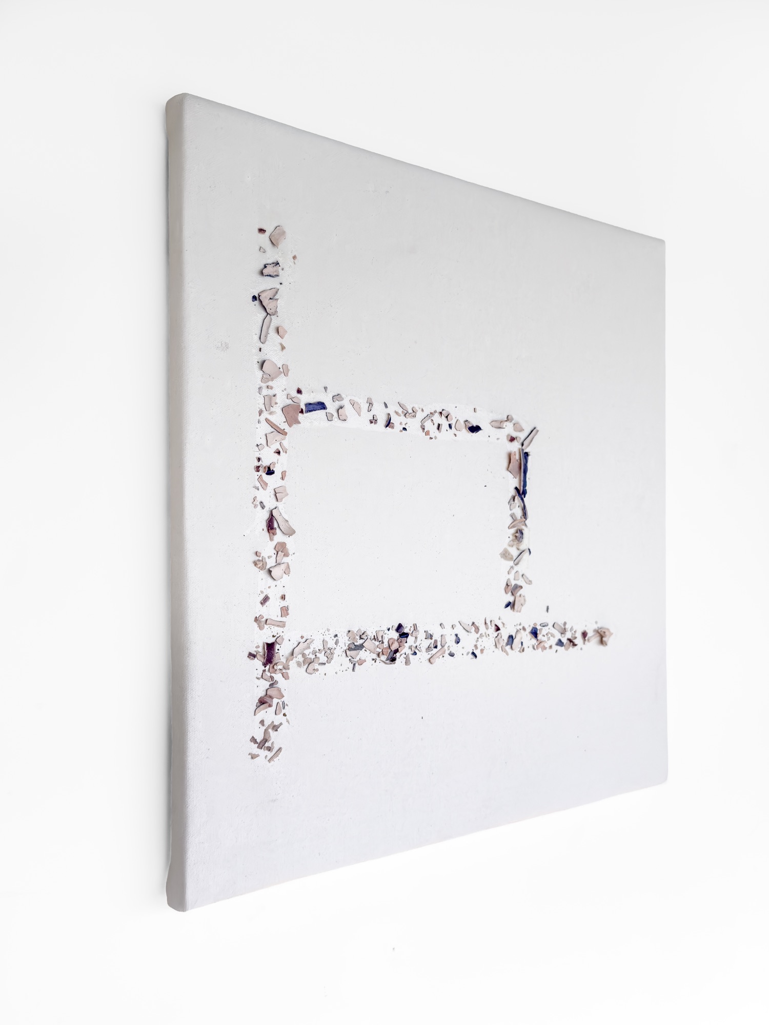Things Stripped — the square canvas seen at an angle, the outline of a small frame traced on it in ceramic flakes
