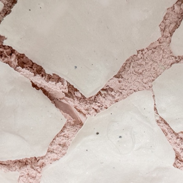 Detail: plates of white glaze lifted and split apart over the pink body beneath