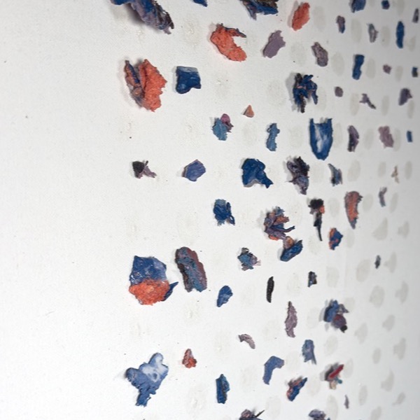 Splinters in Order — blue and orange porcelain splinters scattered across a white ground, with the faint impressions where others sat