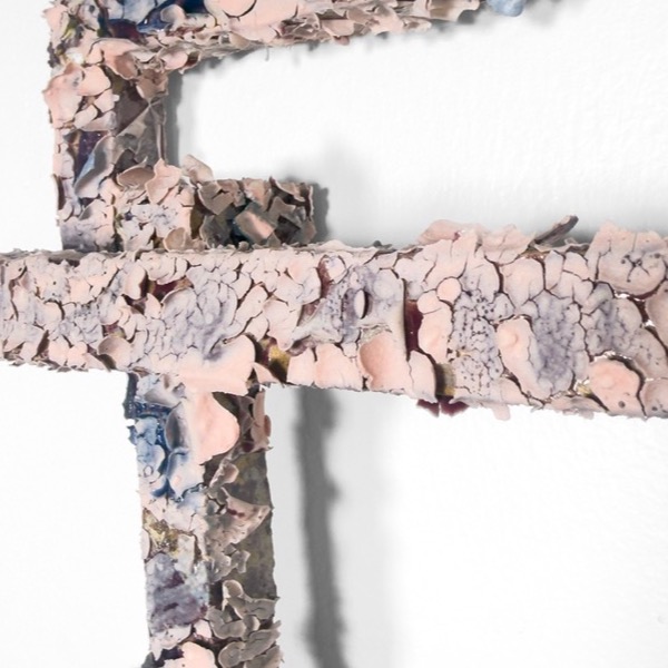 Detail: crust of pink and blue glaze plates over the frame